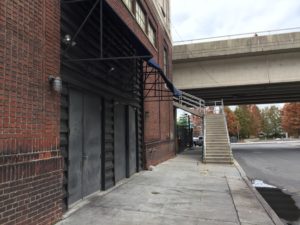 The exit of Downstairs Live as viewed from outside. On the left is the exit, and on the right of the picture are stairs leading to the upper level of Walnut Street.