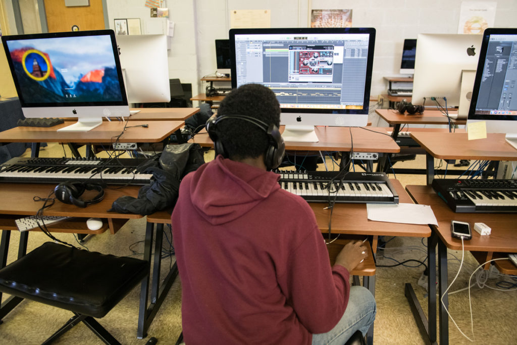A student works on producing his own tracks in the music technology lab at Hill-Freedman World Academy.