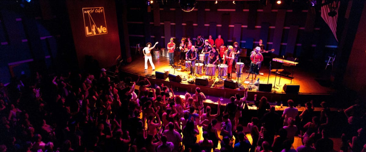 Image of band on stage at WCL in front of a full audience.